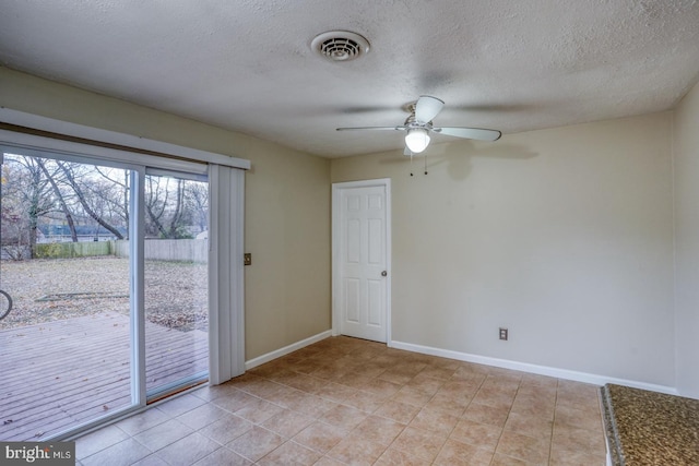 unfurnished room featuring a textured ceiling and ceiling fan