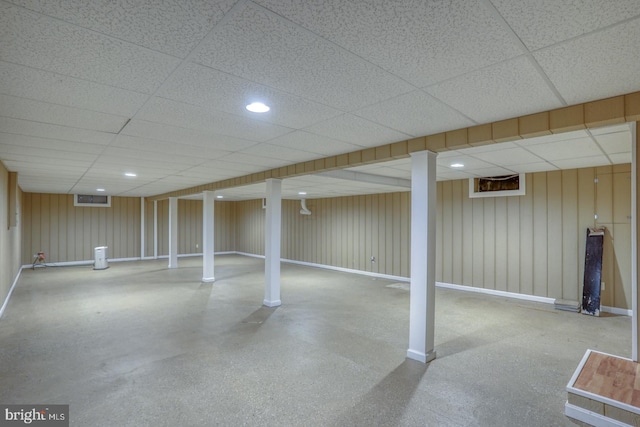 basement with a paneled ceiling