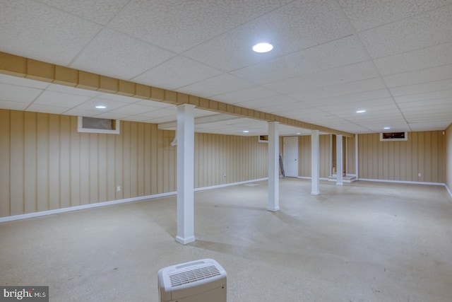 basement with a paneled ceiling