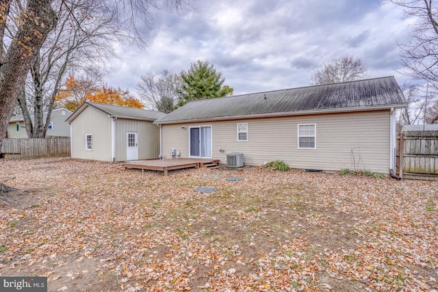 back of house with a deck and central AC unit