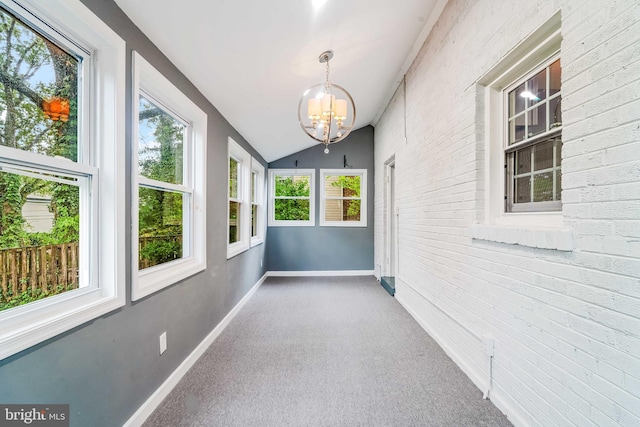 unfurnished sunroom featuring a chandelier and vaulted ceiling