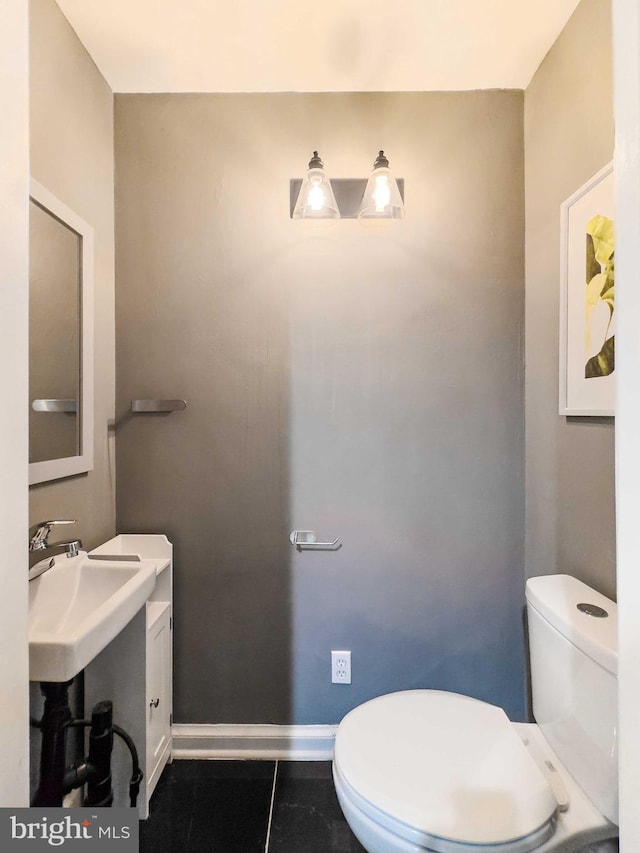 bathroom with tile patterned floors, toilet, and sink