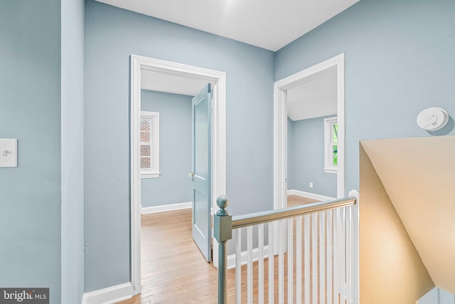 corridor with light hardwood / wood-style floors