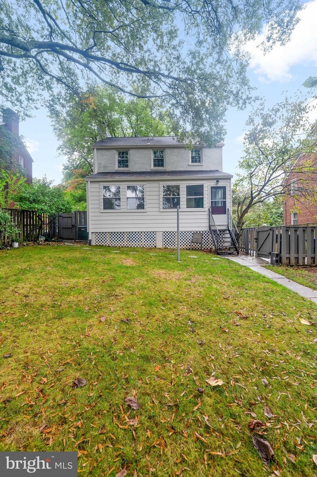 rear view of house with a lawn