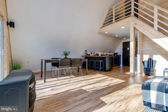 living room featuring light hardwood / wood-style floors and a towering ceiling