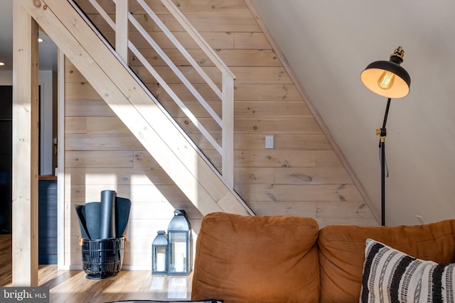 interior space with wooden walls and hardwood / wood-style floors