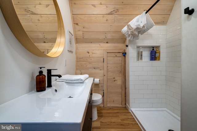 bathroom featuring wooden walls, hardwood / wood-style flooring, wooden ceiling, toilet, and lofted ceiling