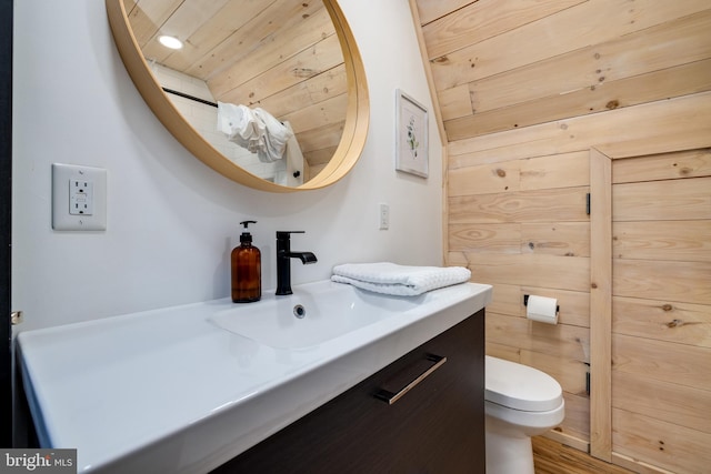 bathroom featuring toilet, vanity, wooden ceiling, and wood-type flooring