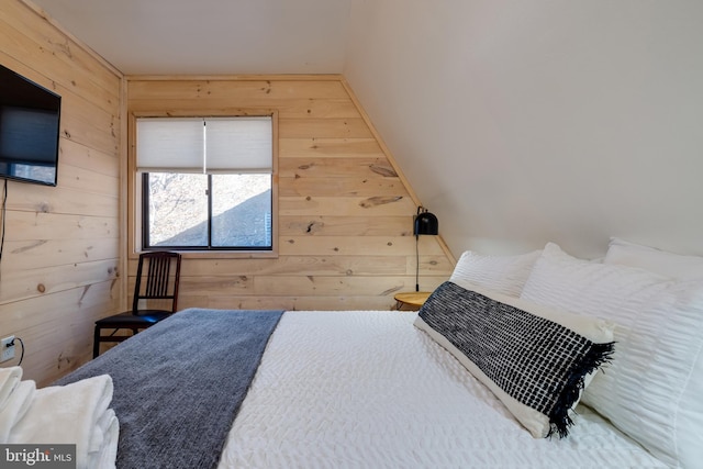 bedroom featuring wood walls