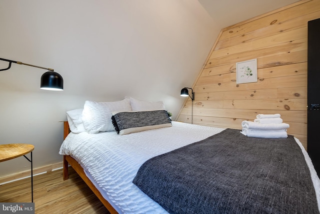 bedroom featuring hardwood / wood-style flooring and vaulted ceiling