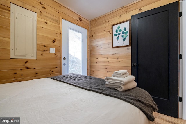 bedroom featuring wooden walls