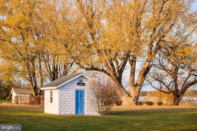 view of outbuilding featuring a yard