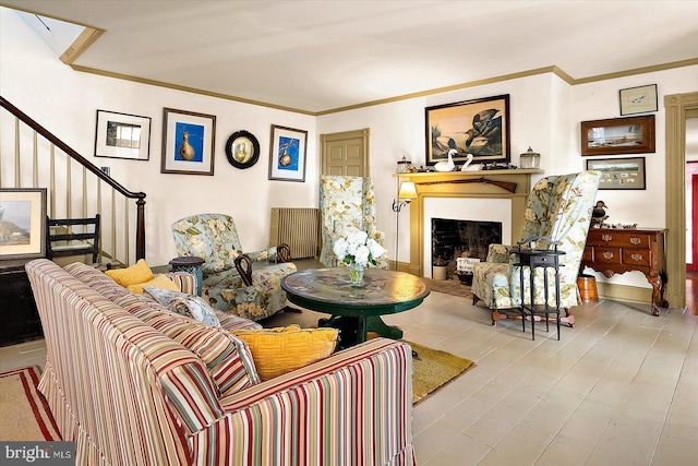 living room with ornamental molding and light hardwood / wood-style floors