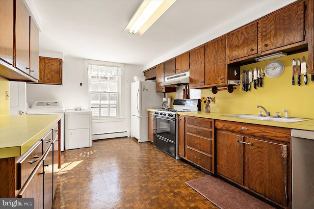 kitchen featuring dishwasher, washing machine and dryer, black range with gas cooktop, dark parquet floors, and a baseboard radiator