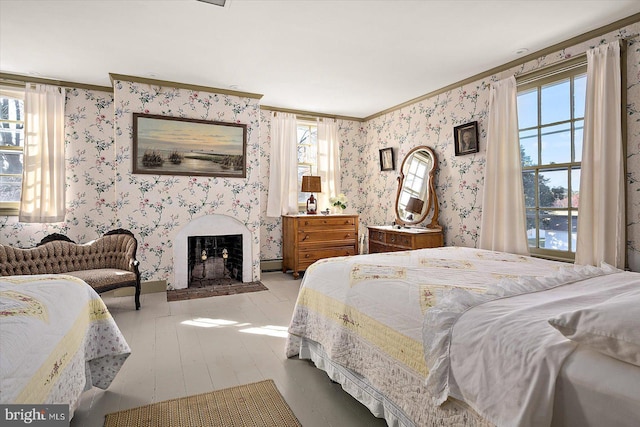 bedroom with ornamental molding and multiple windows