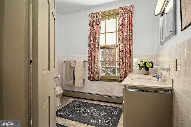 bathroom featuring toilet, a baseboard radiator, tile walls, tile patterned floors, and vanity