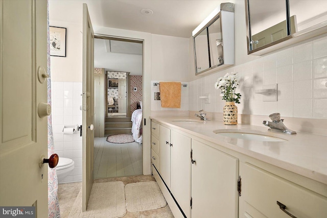 bathroom featuring tile walls, tile patterned floors, vanity, and toilet