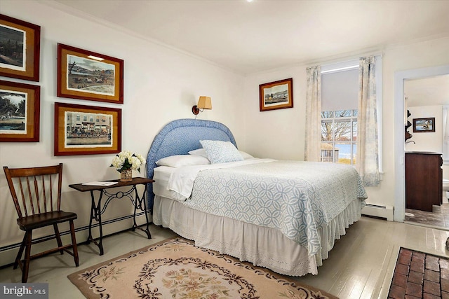 bedroom featuring light wood-type flooring, a baseboard heating unit, and ornamental molding