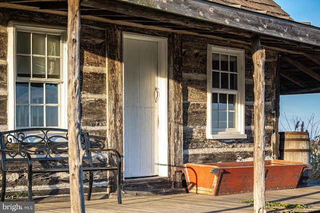 view of exterior entry with a deck