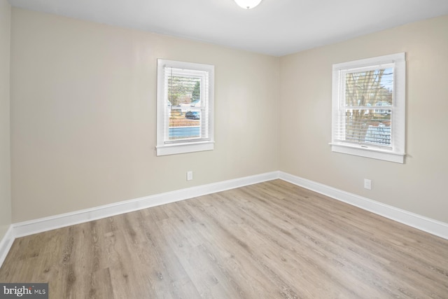 spare room with plenty of natural light and light wood-type flooring