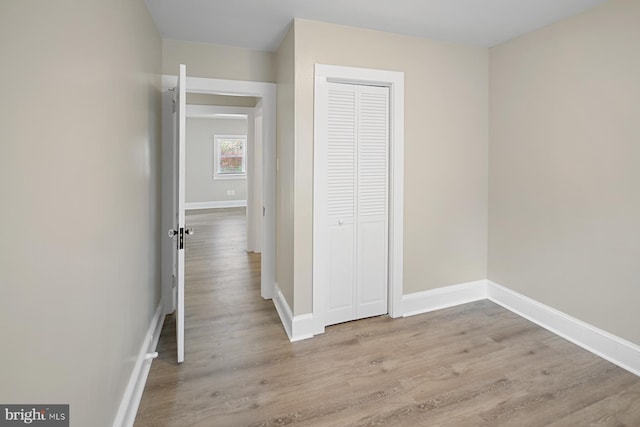 hallway with light hardwood / wood-style flooring