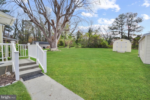 view of yard featuring a wooden deck and a shed