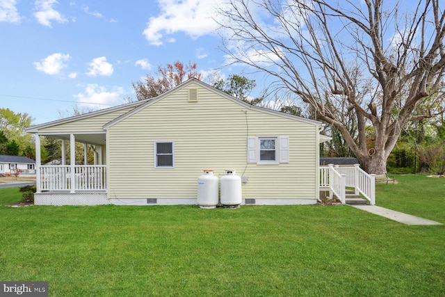 view of home's exterior with a lawn and covered porch