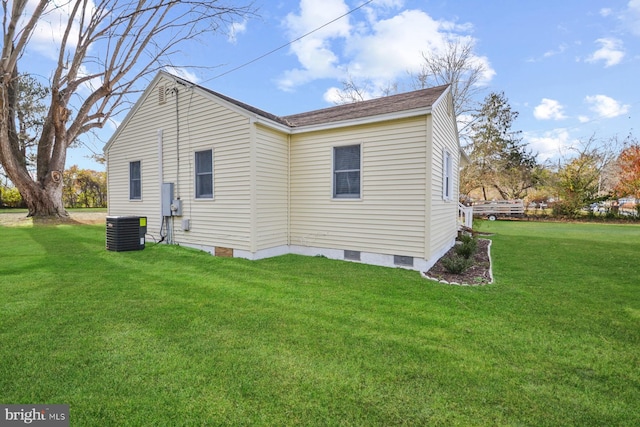 back of house featuring central AC unit and a yard