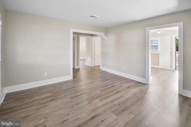 unfurnished room with hardwood / wood-style floors