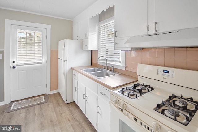 kitchen featuring white appliances, white cabinetry, a wealth of natural light, and sink