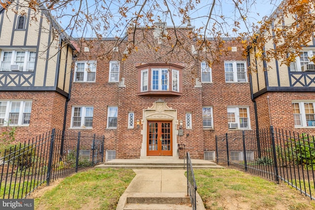 view of front of home featuring french doors and cooling unit