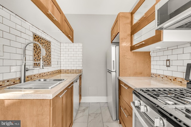 kitchen with decorative backsplash, sink, and stainless steel appliances