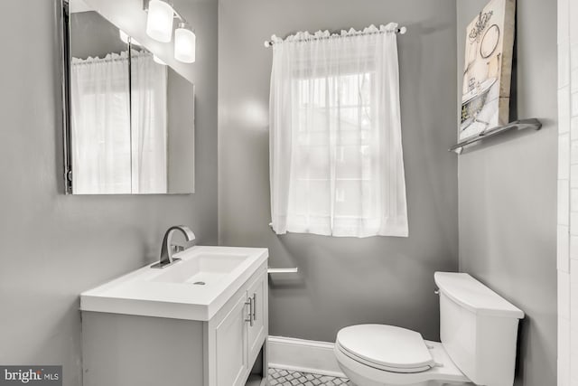 bathroom featuring tile patterned floors, vanity, and toilet