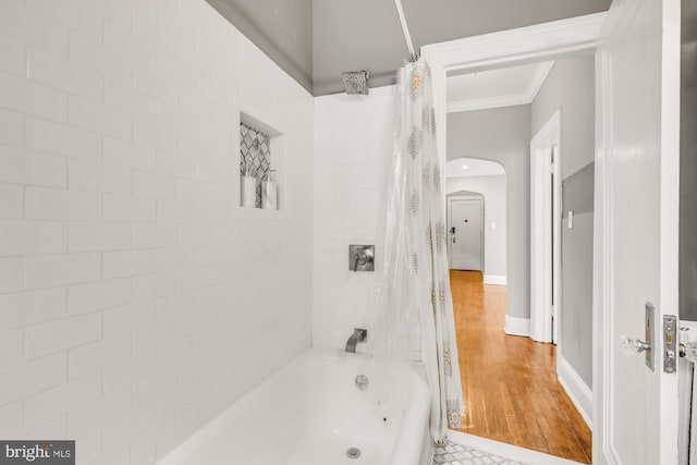 bathroom with ornamental molding, shower / bath combo, and hardwood / wood-style flooring