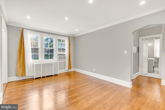 unfurnished room featuring crown molding, radiator, and light hardwood / wood-style flooring