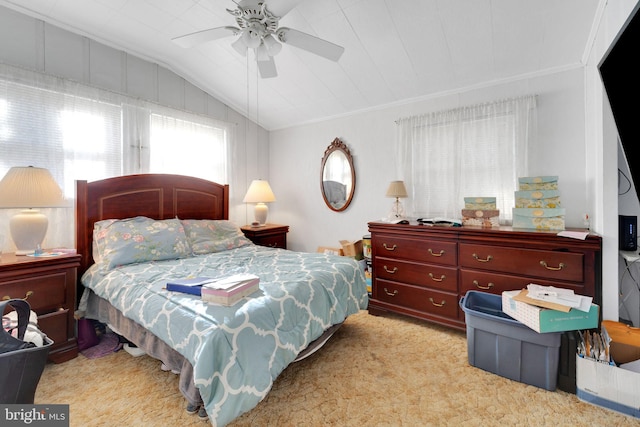 carpeted bedroom with ceiling fan and vaulted ceiling