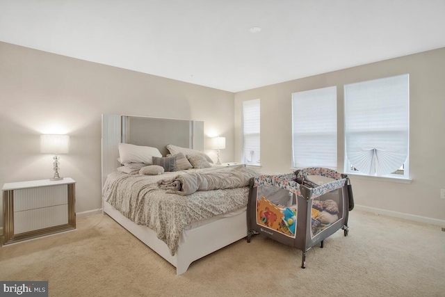 bedroom featuring light colored carpet