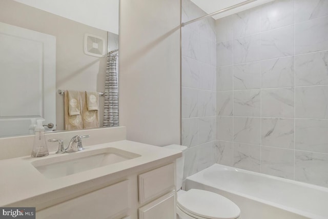 full bathroom featuring vanity, toilet, and tiled shower / bath