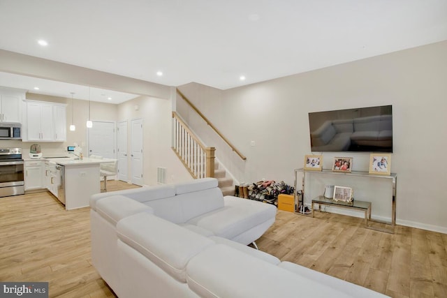 living room with light hardwood / wood-style flooring