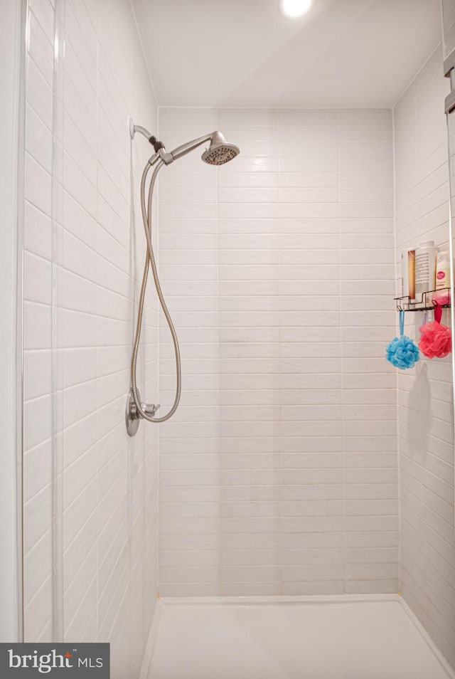 bathroom with tiled shower