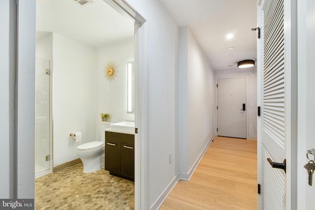 hall with light hardwood / wood-style floors