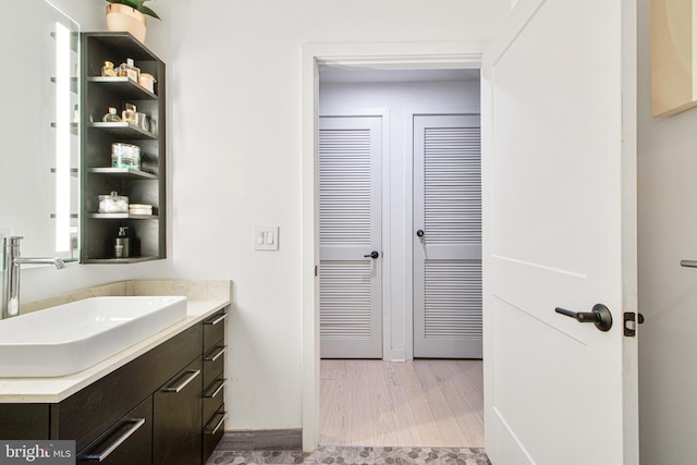 bathroom featuring wood-type flooring and vanity