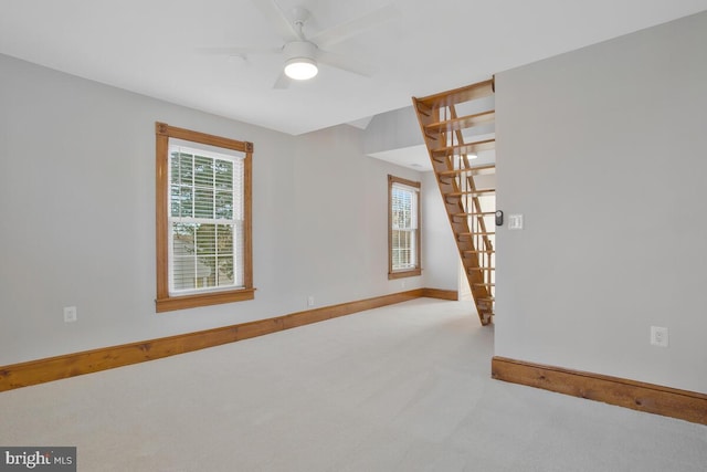 carpeted spare room featuring ceiling fan