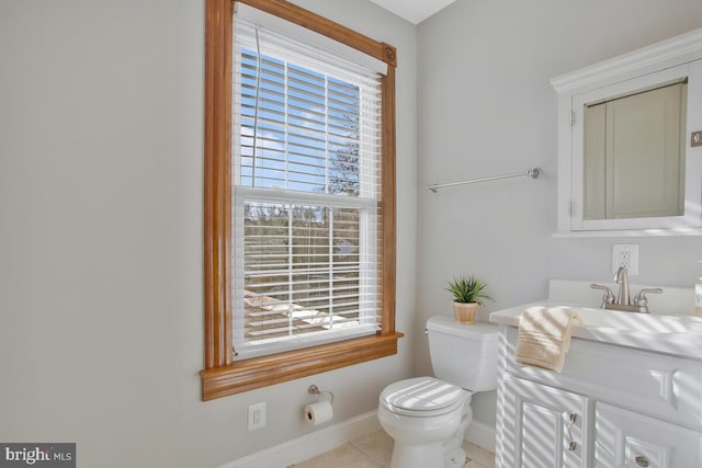 bathroom featuring toilet, tile patterned flooring, and vanity