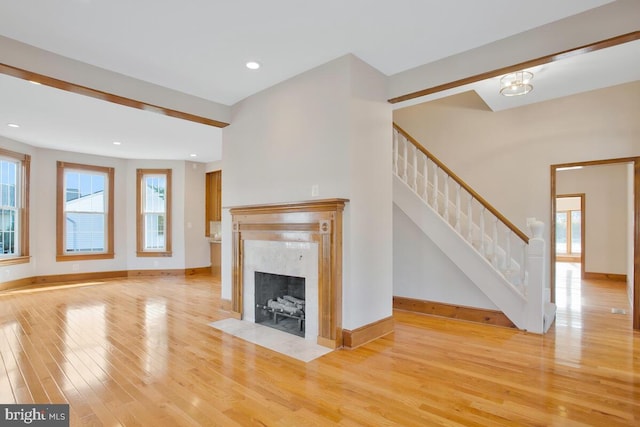 unfurnished living room with light hardwood / wood-style flooring and a fireplace