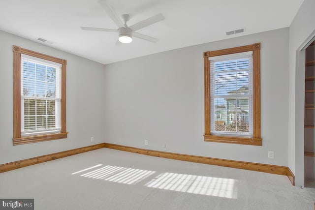 unfurnished room with ceiling fan and light carpet