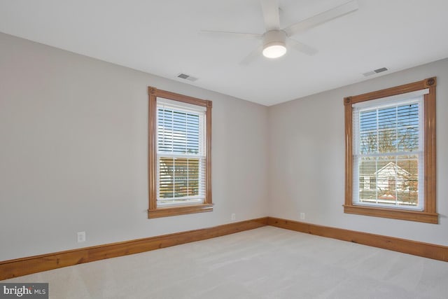 carpeted empty room featuring ceiling fan