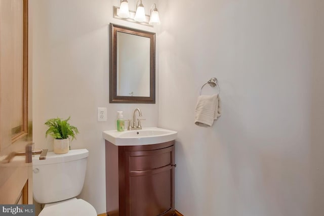 bathroom featuring toilet and vanity