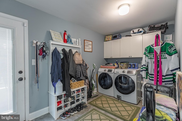 laundry room featuring cabinets and washer and clothes dryer