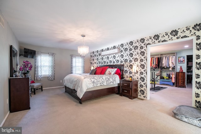 bedroom featuring carpet flooring, an inviting chandelier, and a closet